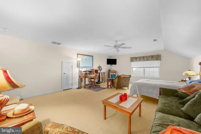 a view of a house with backyard and trees