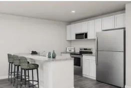 a kitchen with stainless steel appliances a refrigerator a stove a sink and a microwave