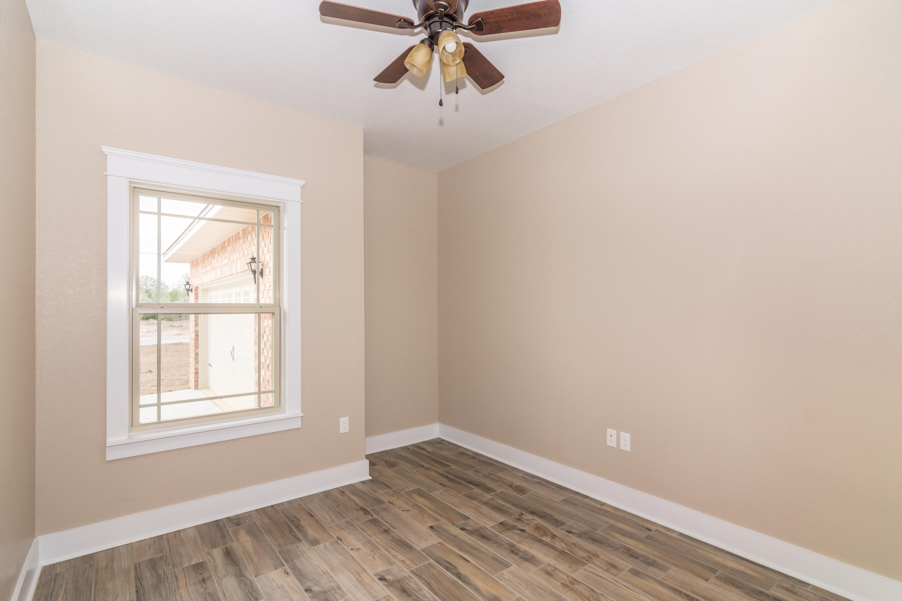 4088 Happy Trails Road Crestview, FL 32539 - Photo 14 of 27 an empty room with a window and a ceiling fan
