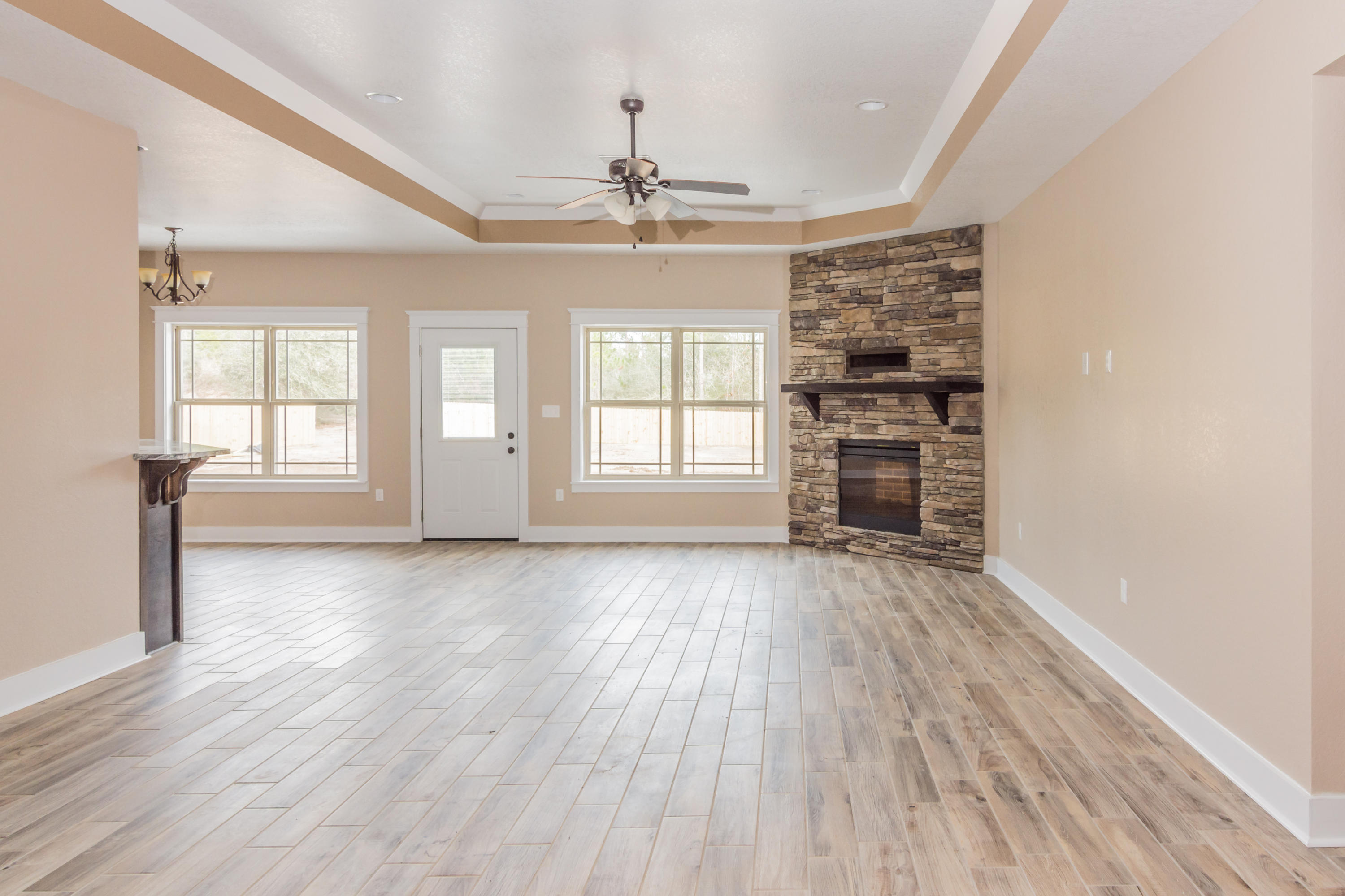 4088 Happy Trails Road Crestview, FL 32539 - Photo 3 of 27 wooden floor in an empty room with a window