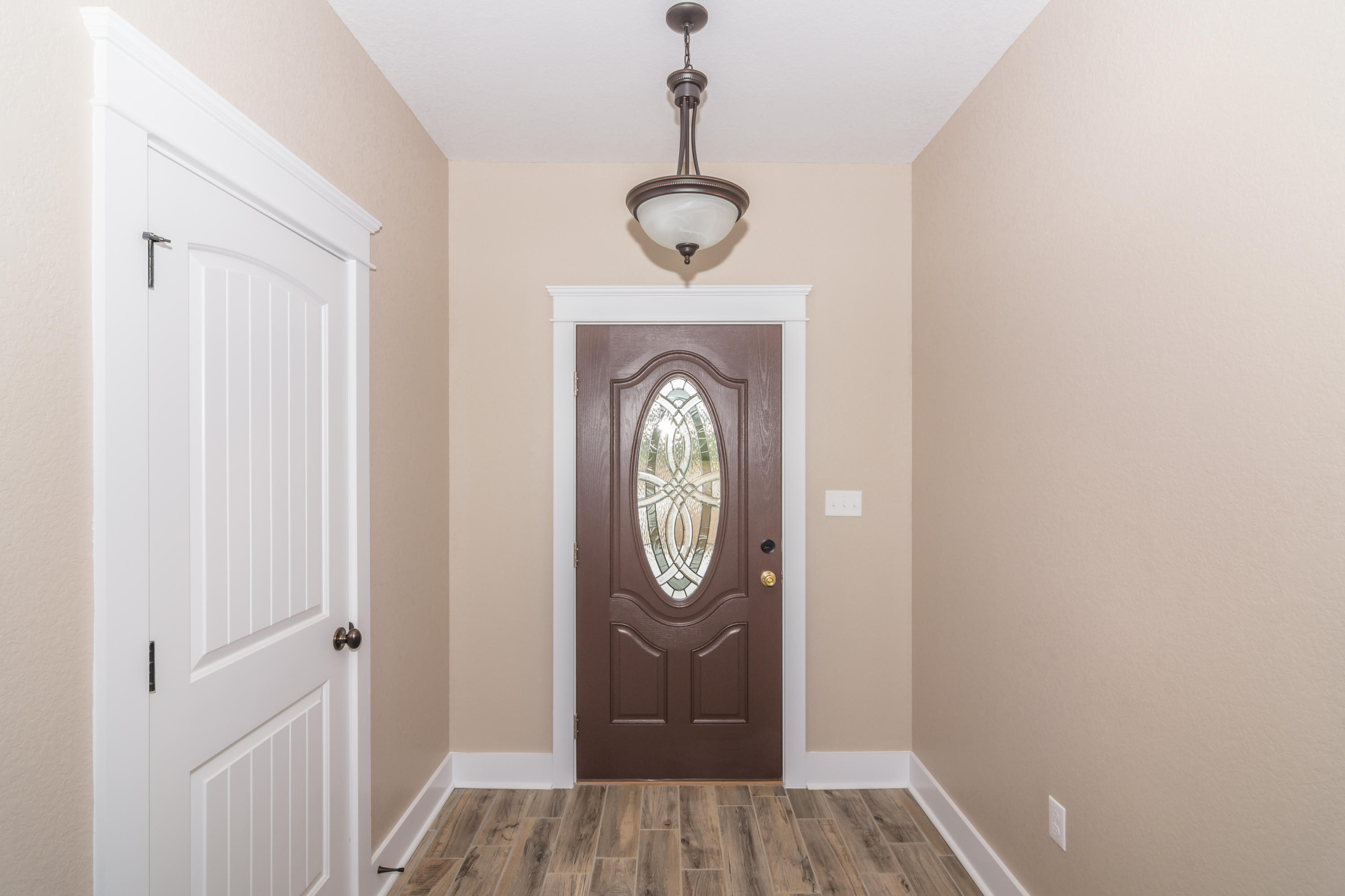 4088 Happy Trails Road Crestview, FL 32539 - Photo 8 of 27 a view of a hallway with washer and dryer