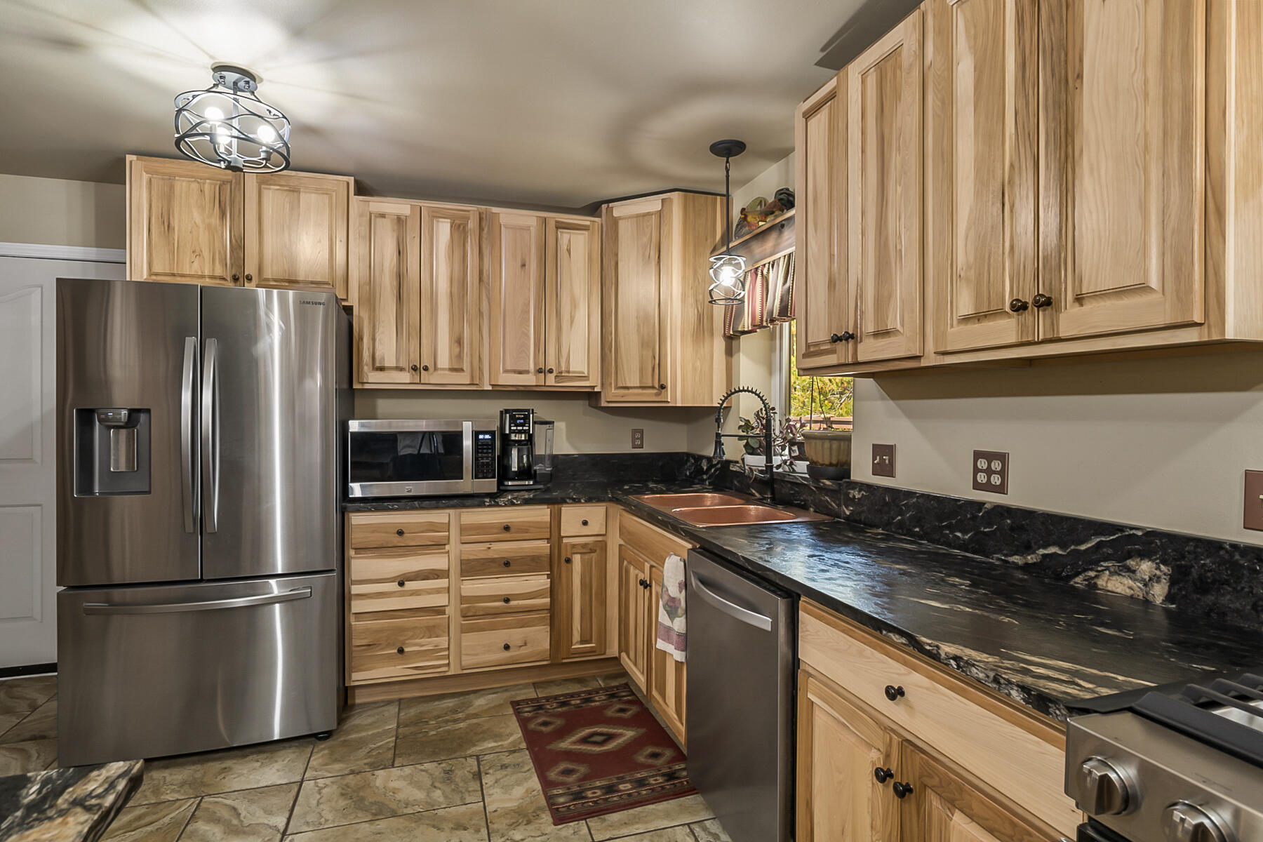 15730 Jackpine Road La Pine, OR 97739 - Photo 16 of 43 a kitchen with a refrigerator a sink and cabinets