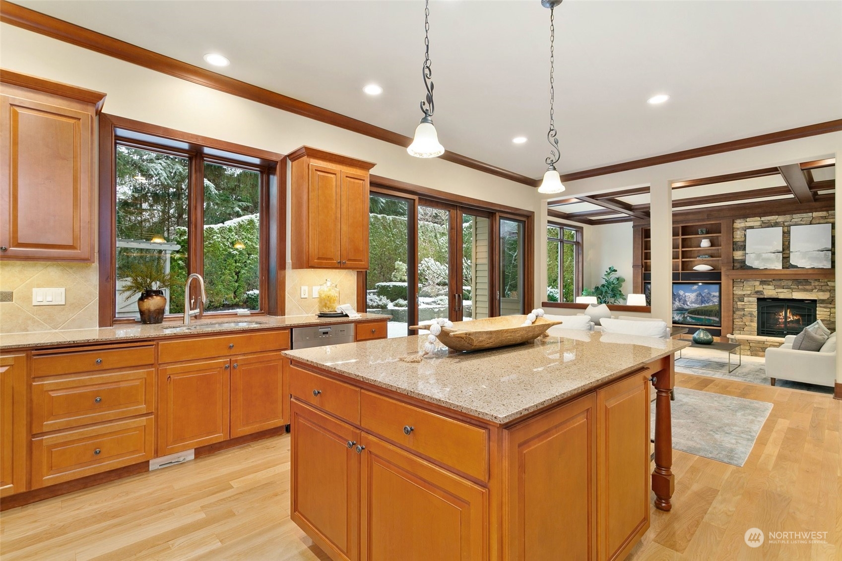 573 Saddleback Loop Way Northwest Issaquah, WA 98027 - Photo 11 of 40 a kitchen with a stove a sink dishwasher a kitchen island with wooden cabinets and floor