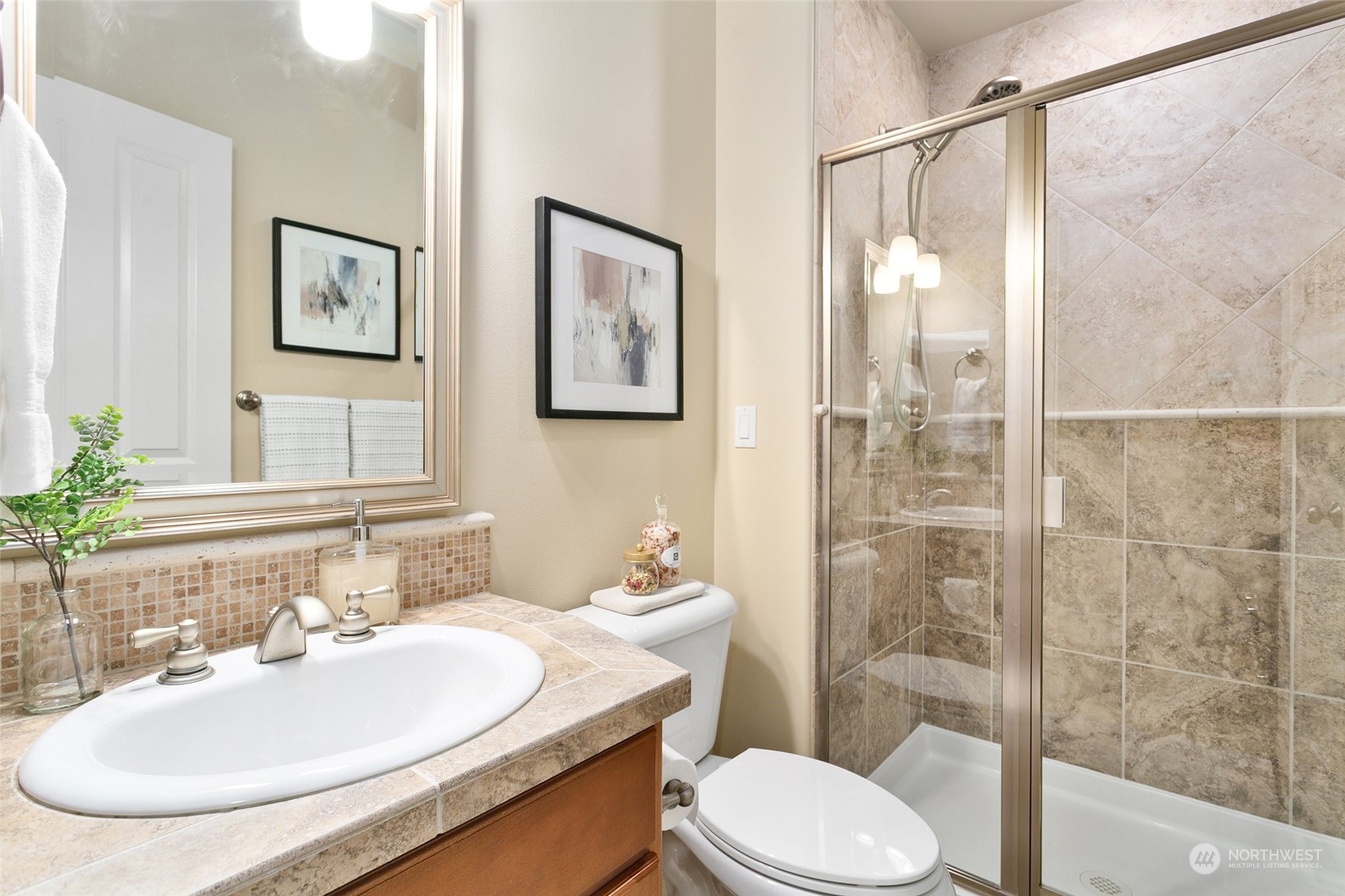 573 Saddleback Loop Way Northwest Issaquah, WA 98027 - Photo 16 of 40 a bathroom with a sink toilet and shower