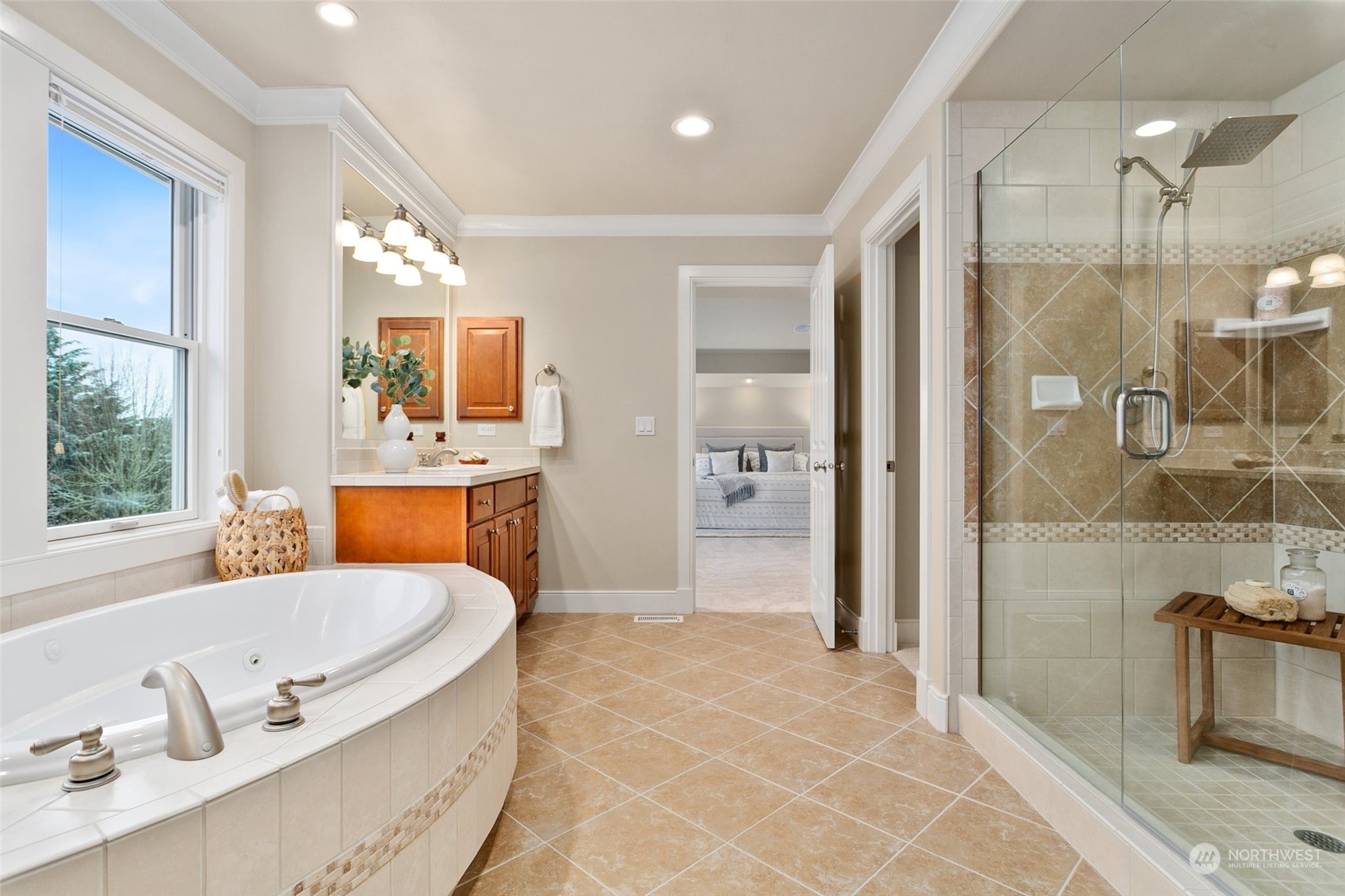 573 Saddleback Loop Way Northwest Issaquah, WA 98027 - Photo 22 of 40 a bathroom with a tub a sink a mirror and a shower
