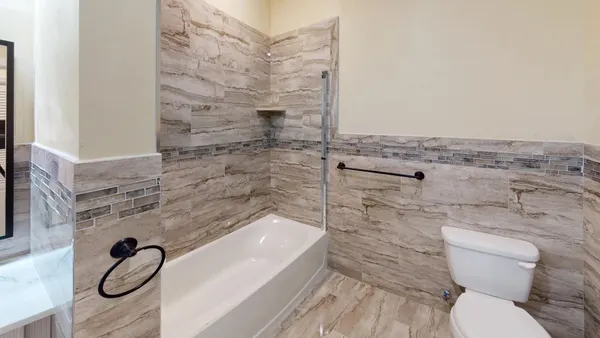 a bathroom with a toilet and a shower
