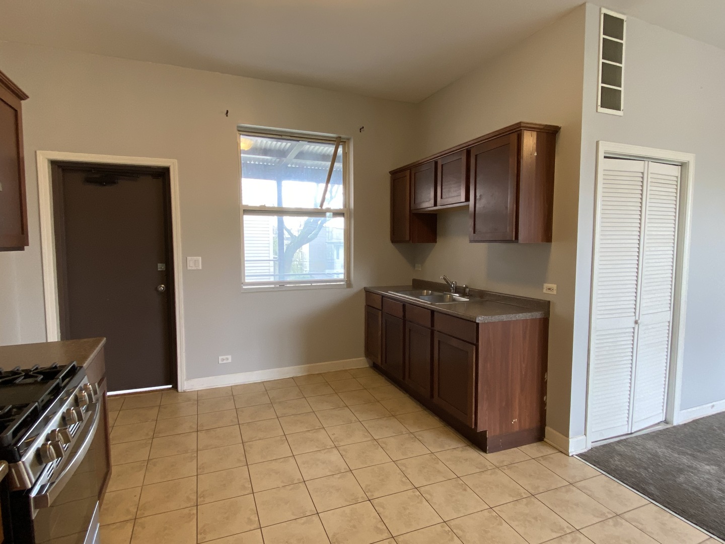 Undisclosed Address Chicago, IL 60622 - Photo 7 of 18 a kitchen with stainless steel appliances granite countertop a stove a refrigerator and a sink
