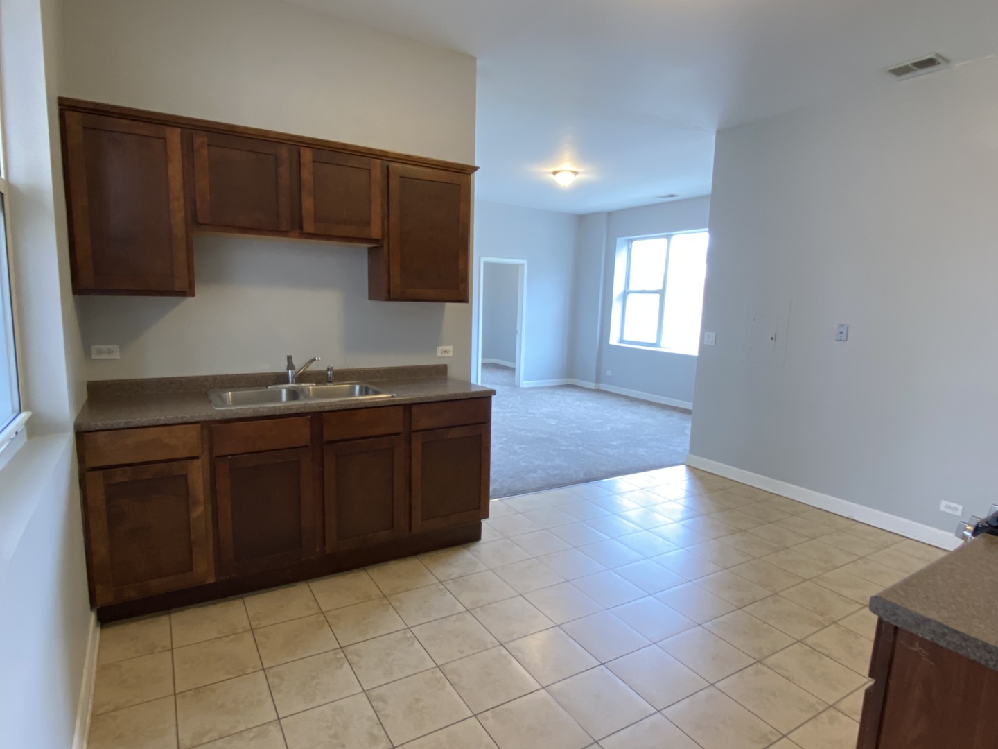 Undisclosed Address Chicago, IL 60622 - Photo 8 of 18 a kitchen with granite countertop a stove a microwave and wooden cabinets