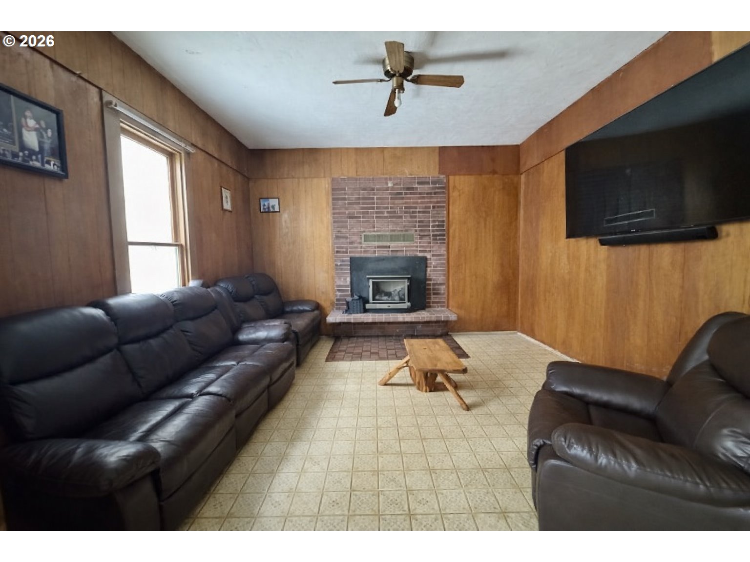 63563 Booth Lane La Grande, OR 97850 - Photo 12 of 24 a living room with furniture a flat screen tv and a fireplace