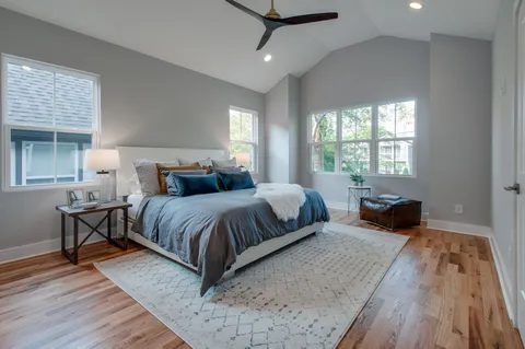 a bedroom with a large bed and a chandelier