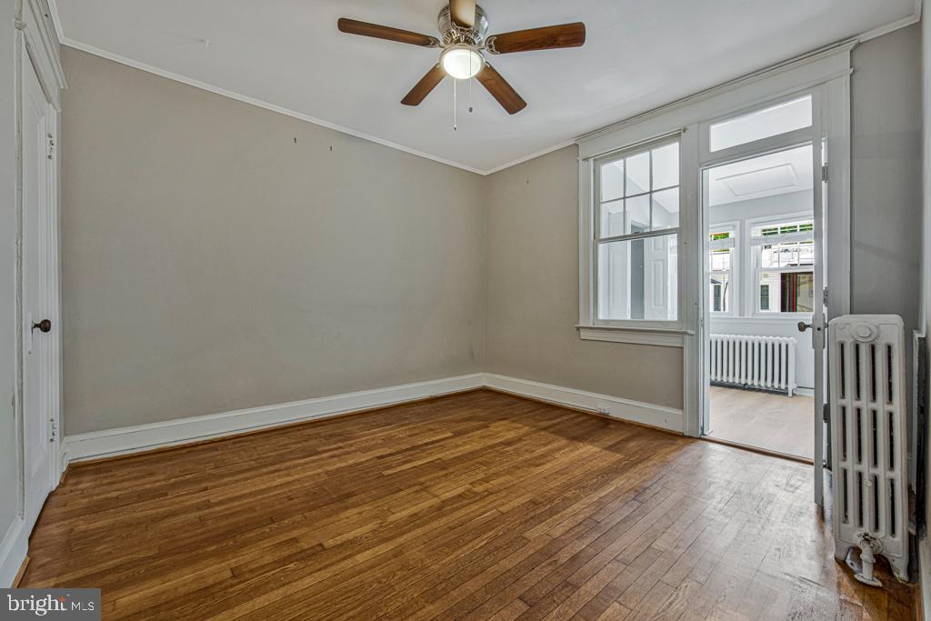 2406 37th Street Northwest Washington, DC 20007 - Photo 8 of 44 wooden floor in an empty room with a window