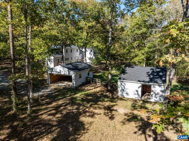 a view of a house with a yard and sitting area