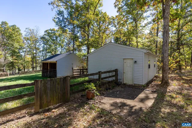 a backyard of a house with barbeque oven table and chairs