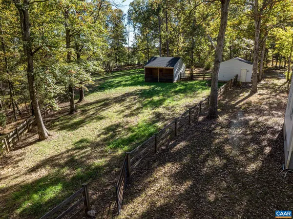 a view of a yard with wooden fence