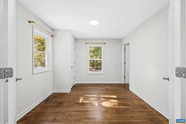 a bathroom with a granite countertop sink toilet and a mirror
