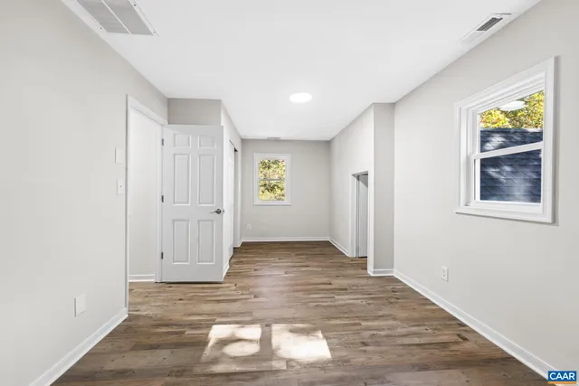 a kitchen with stainless steel appliances a refrigerator and a wooden floor