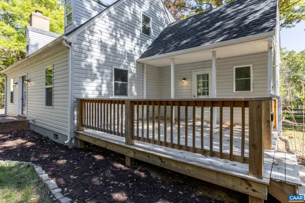 a side view of a house with a bench