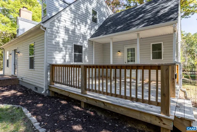 a side view of a house with a bench