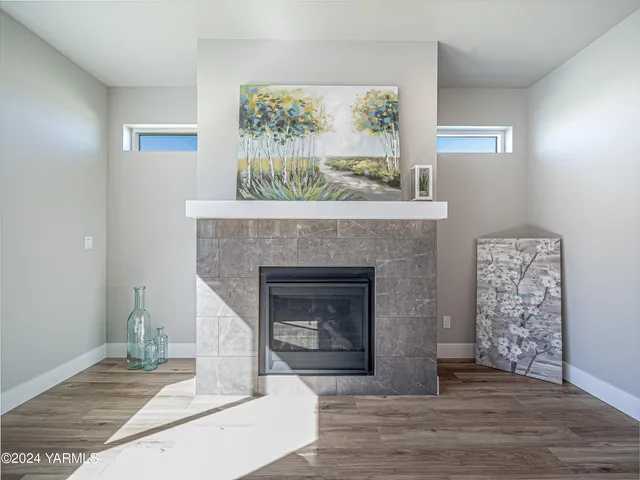 a living room with a fireplace and a painting