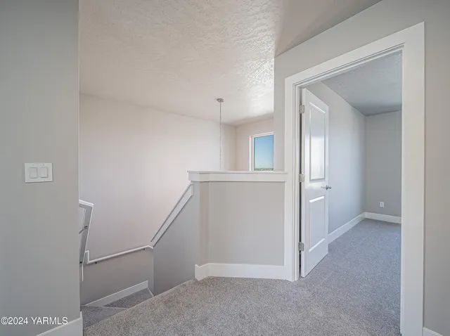 a view of a kitchen with white cabinets and a wooden floor