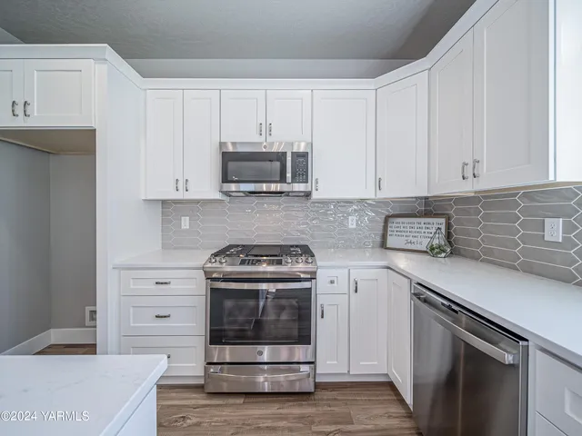 a kitchen with cabinets stainless steel appliances and a sink