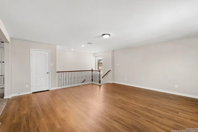 a view of a room with wooden floor