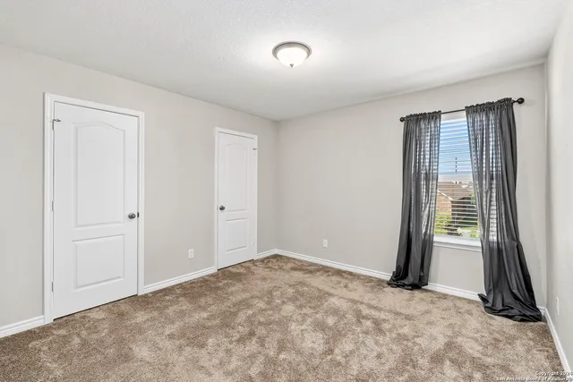 an empty room with closet area
