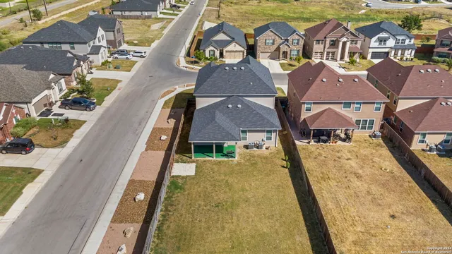 an aerial view of residential houses with outdoor space
