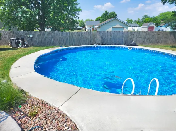 a view of a swimming pool with wooden fence