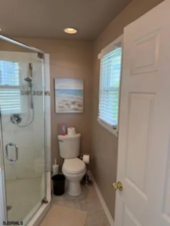 a bathroom with a toilet sink and shower