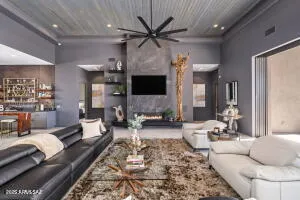 a kitchen with stainless steel appliances kitchen island granite countertop a table chairs and a refrigerator