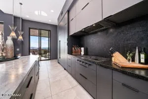a kitchen with stainless steel appliances granite countertop a sink stove and cabinets