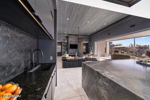 1313 Tortolita Mountain Circle Tucson, AZ 85755 - Photo 18 of 46 a kitchen with stainless steel appliances granite countertop a sink stove and cabinets
