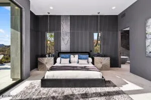 a large bedroom with a large bed and large windows