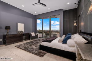 1313 Tortolita Mountain Circle Tucson, AZ 85755 - Photo 26 of 46 a large bedroom with a large bed and large windows