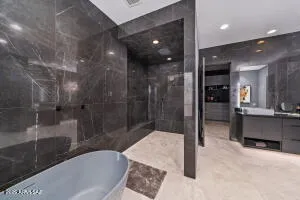 a kitchen with stainless steel appliances kitchen island granite countertop a refrigerator and a sink