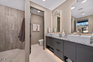 1313 Tortolita Mountain Circle Tucson, AZ 85755 - Photo 33 of 46 a bathroom with a granite countertop sink and a mirror
