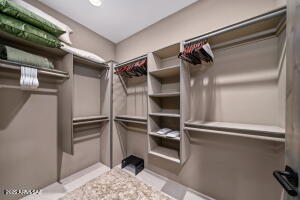 1313 Tortolita Mountain Circle Tucson, AZ 85755 - Photo 34 of 46 a view of walk in closet with clothes and shoes