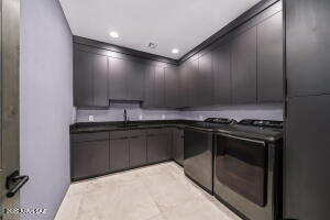 1313 Tortolita Mountain Circle Tucson, AZ 85755 - Photo 35 of 46 a kitchen with granite countertop a stove and a sink