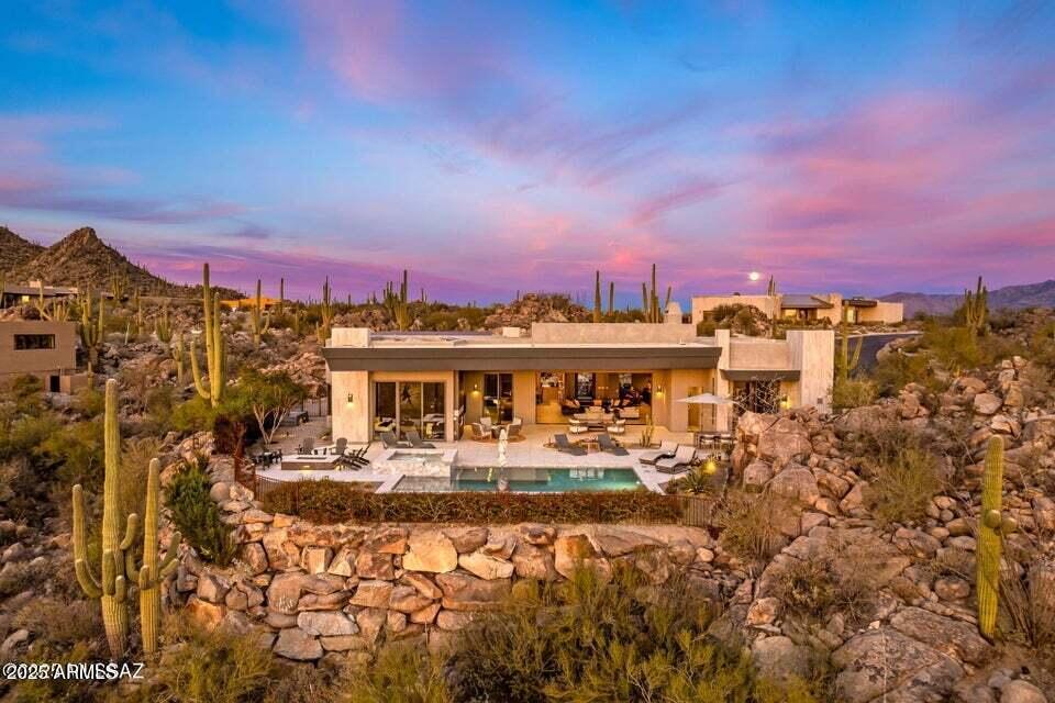1313 Tortolita Mountain Circle Tucson, AZ 85755 - Photo 46 of 46 a view of a lake with a building in the background