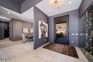1313 Tortolita Mountain Circle Tucson, AZ 85755 - Photo 7 of 46 a spacious bedroom with a large bed and a chandelier