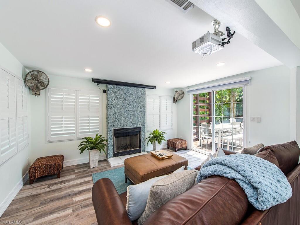 778 5th Avenue North Naples, FL 34102 - Photo 14 of 23 a living room with a couch and a fireplace
