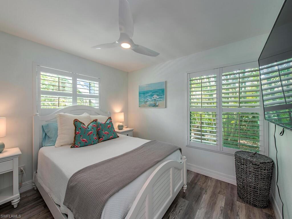 778 5th Avenue North Naples, FL 34102 - Photo 17 of 23 a bedroom with a bed and a chair