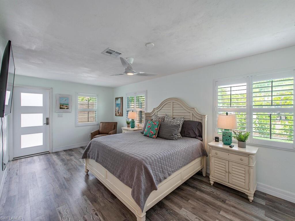 778 5th Avenue North Naples, FL 34102 - Photo 18 of 23 a bedroom with a large bed and windows