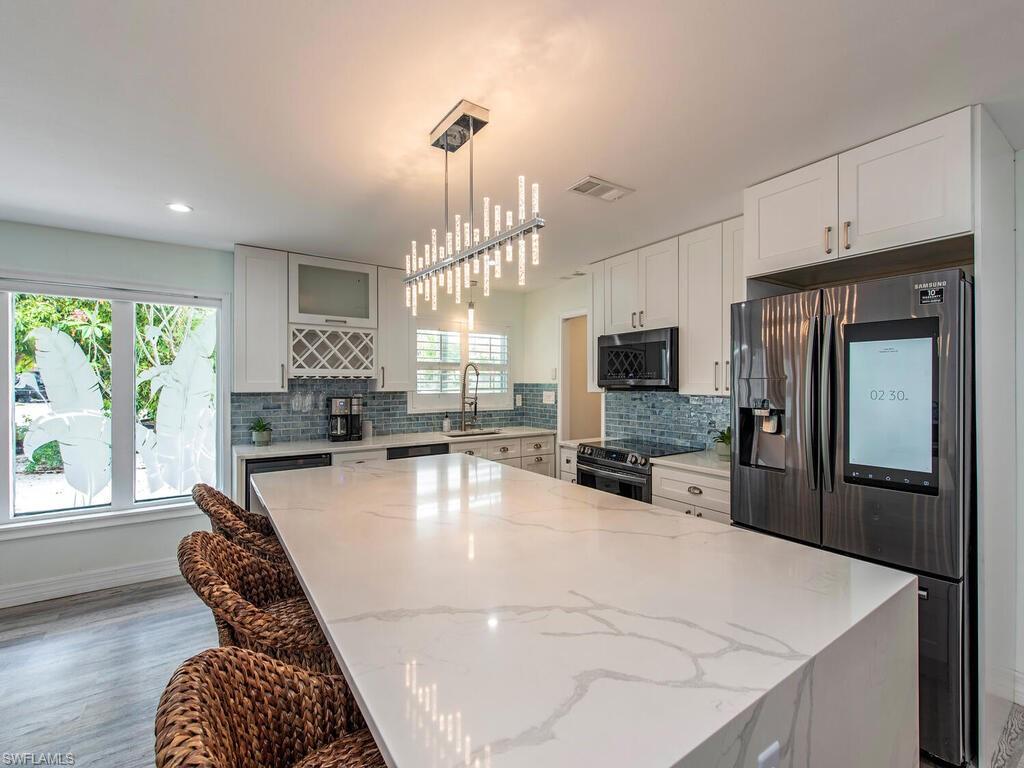 778 5th Avenue North Naples, FL 34102 - Photo 20 of 23 a kitchen with stainless steel appliances granite countertop a sink a stove and a refrigerator