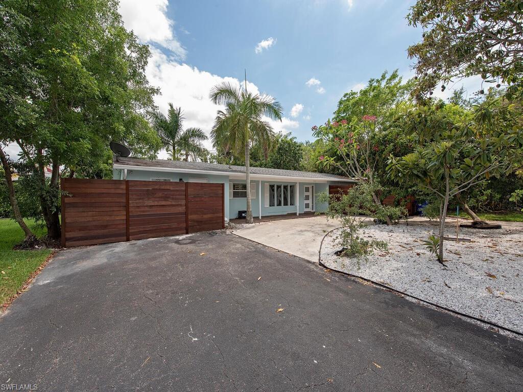 778 5th Avenue North Naples, FL 34102 - Photo 4 of 23 a view of a house with a backyard and tree