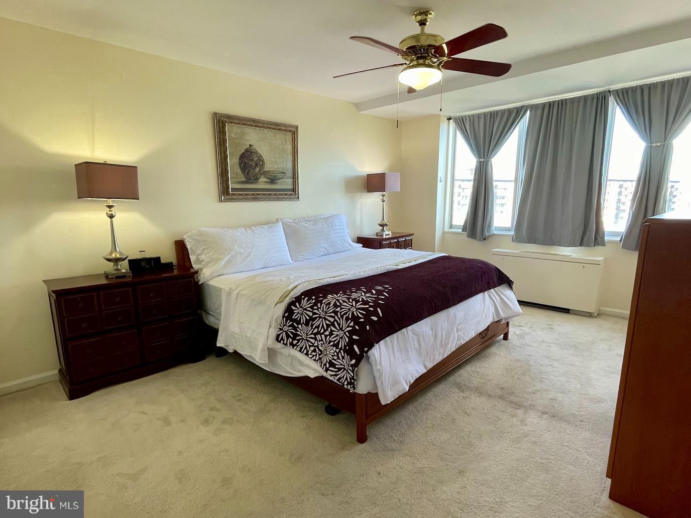 301 North Beauregard Street, Unit 1201 Alexandria, VA 22312 - Photo 1 of 7 a bedroom with a bed lamp and a large window