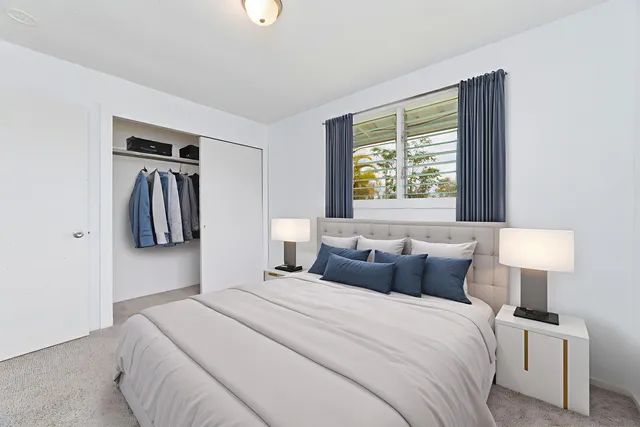 a bedroom with a bed and a lamp