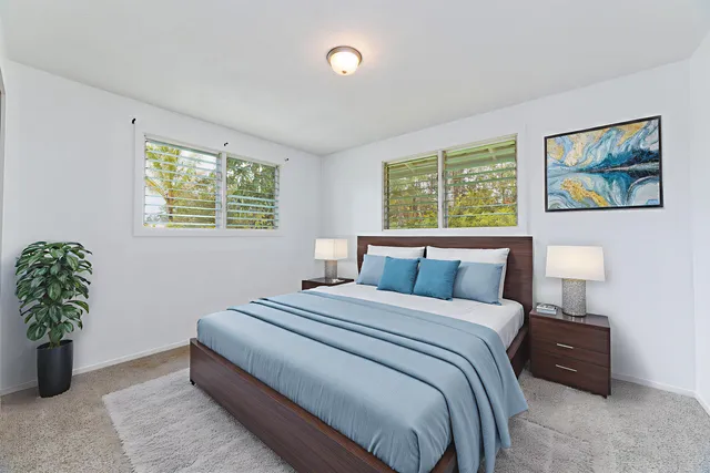 a bedroom with bed and a potted plant