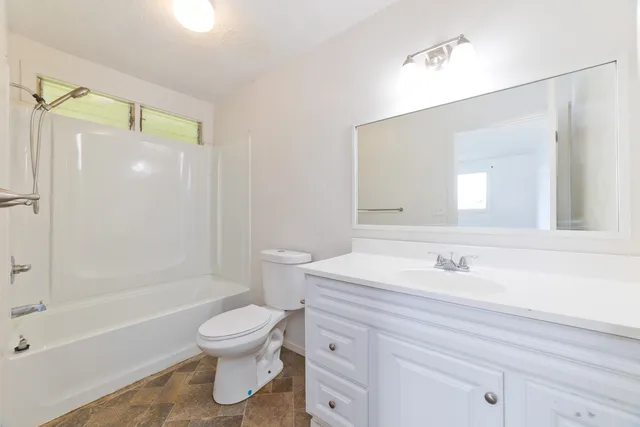 a bathroom with a sink toilet tub and shower